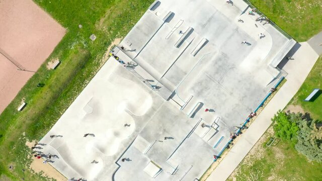 Skate Park From Above. Skateboarders Have A Fun In Sport Area. Outdoor Activities Theme.