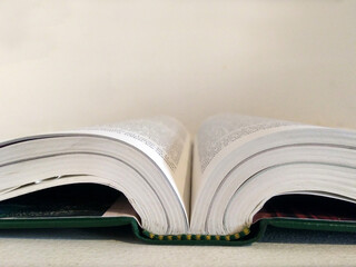 open book on white desk