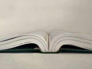 open book on white desk
