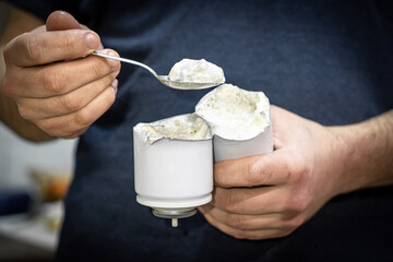 The man cut a can of cream and eats the remnants of the cream. Damaged spray of cream