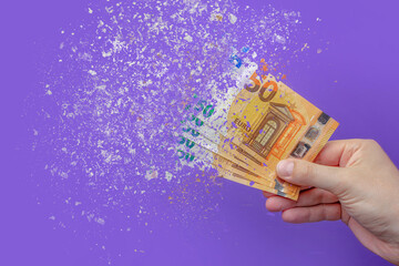 inflation euro . Inflation in Europe, hyper inflation. Banner with purple background. Fifty euro banknotes sprayed in the hand of a man on a purple background. - obrazy, fototapety, plakaty