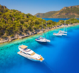 Aerial view of beautiful yachts and boats on the sea at sunset in summer. Gemiler Island in Turkey....