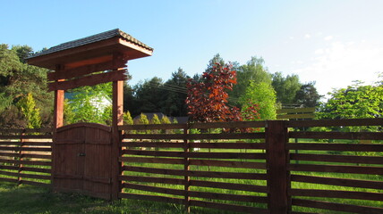 Fototapeta na wymiar Garden with a fence for various plants