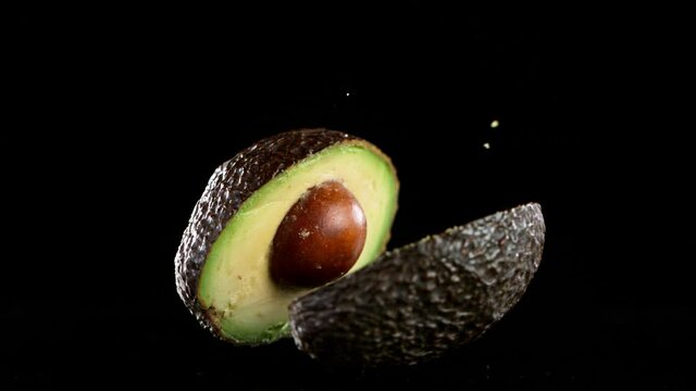 Super slow motion of falling avocado filmed on high speed cinematic camera at 1000 fps.