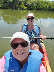 Mother and daughter in kayak on open water