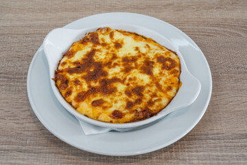 Lasagne alla Bolognese, Baked with Meat Ragu on a White Plate Served, in a plate, top view.