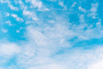 Blue sky background with soft transparent clouds.