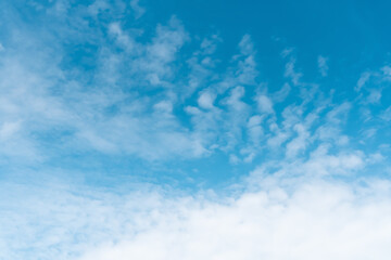 Fototapeta na wymiar Blue sky with fluffy transparent clouds.