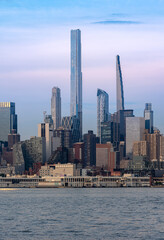 Obraz premium New York, NY - USA- June 8, 2021: Vertical view of Manhattan's westside, featuring the Steinway Tower and Central Park Tower at sunset.