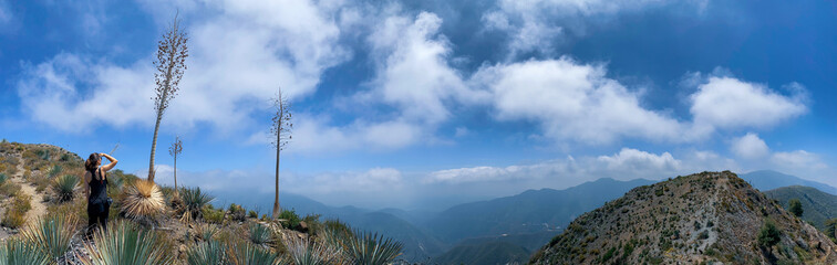 Woman overlooking a panoramic view of Angeles Crest Highway from Hoyt Mountain