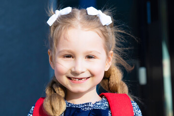 little girl smiling without front milk tooth, permanent molar grow. Dental hygiene concept. closeup portrait of cute funny clever schoolgirl. back to school kid. happy child goes to first grade.