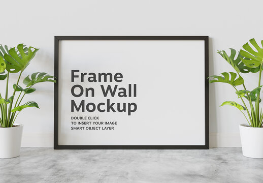 Black Frame Mockup Leaning on Wall with Plants