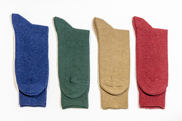 A few of new solid colored socks on a white background. Cotton textile products