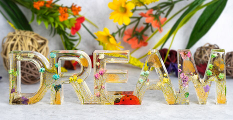 Decoration word dream with colorful bright flowers epoxy resin