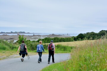 Obraz premium Senior hikers on a path in Brittany France