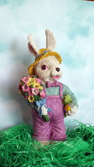 Easter Bunny in cellophane grass with Blue Cloud Background
