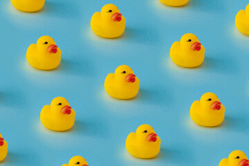 yellow rubber duck pattern, against blue background. creative pattern.