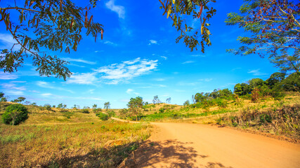Fototapeta premium Rural landscape with clay road on hill