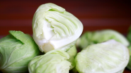 Baby cabbage on wood background.