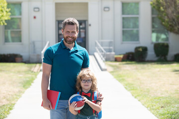 first day at school. father and son come back from school. happy family value.