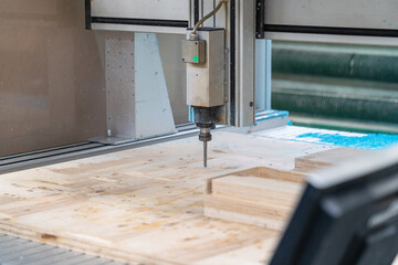 Cnc machine at work process cutting wood with drill, close up.