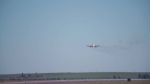 A military aircraft after a tactical flight, lands on the runway. Leaving carbon monoxide from jet engines.
