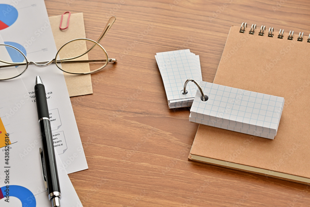Poster a blank word book sits on the desk along with a piece of paper with a dummy graph(with dummy text) p