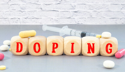 word DOPING on wooden block, medical concept