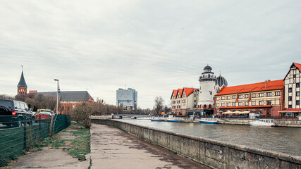 Fototapeta na wymiar Fish Village, House of Soviets and the Cathedral on the banks of the river Pregolya