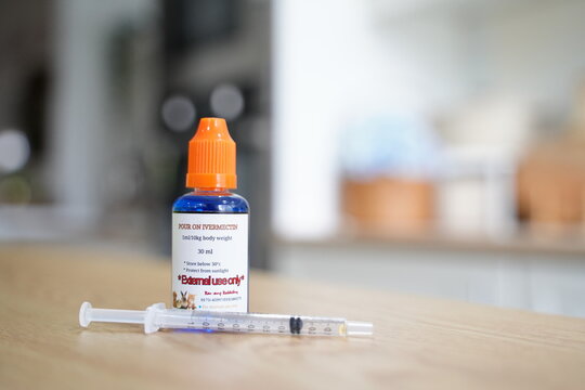 A bottle of Ivermectin medicine on a wooden table. Veterinary medication used to treat Covid19. Healthcare concept