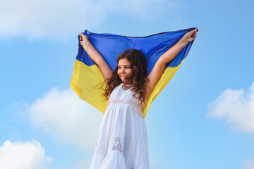 Ukrainian flag blue and yellow flag of Ukraine in hands of happy girl Ukrainian. Independence Day. Flag Day. Constitution day