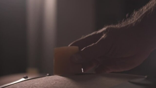Close-up of the hand opening the cork in the barrel. A dark wine cellar. Wooden wine barrel. Slow motion.