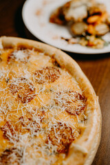 Tasty  pizza and cooking ingredients tomatoes basil on black concrete background. Top view of hot  pizza