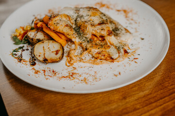 Chicken parmigiana. Traditional Italian comfort dish. Chicken breast covered in breadcrumbs fried, topped with marinara sauce, melted mozzarella, parmigiana and provolone cheeses and Italian parsley.