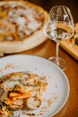 Chicken parmigiana. Traditional Italian comfort dish. Chicken breast covered in breadcrumbs fried, topped with marinara sauce, melted mozzarella, parmigiana and provolone cheeses and Italian parsley.