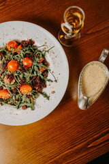 Fresh salad with cucumber  tomato arugula corn and sesame dressing