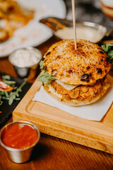 Fresh tasty chicken burger on wood table.