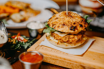 Fresh tasty chicken burger on wood table.