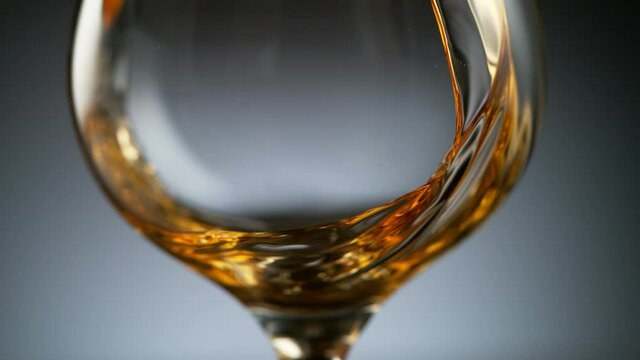 Super slow motion of pouring cognac into glass. Filmed on high speed cinema camera, 1000 fps.