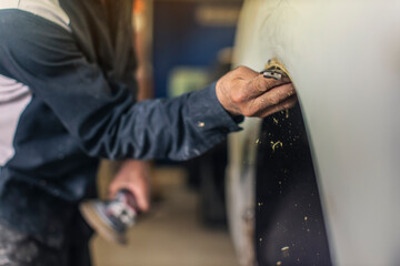 Repair Putty application on a vehicle by an auto body expert