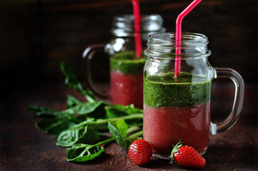 layered smoothies made of strawberries and spinach in a with a handle. 
