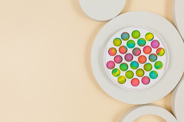 Popular silicone anti-stress pop it toys and geometric shapes for a child on beige background. Trendy Sensory Fidget Toy. Funny Bubble suitable for relieving stress for adults
