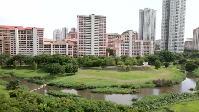 Empty Park Along Kallang River During COVID-19 Pandemic Near Housing And Development In Bishan, Singapore. - aerial ascend, slow motion