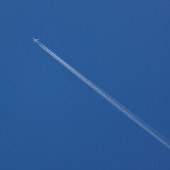 Gazing up at airplane in flight wondering about travel vacations or destinations