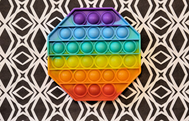 Silicone toy antistress pop it. Trendy antistress sensory toy fidget push  and simple dimple on abstract background