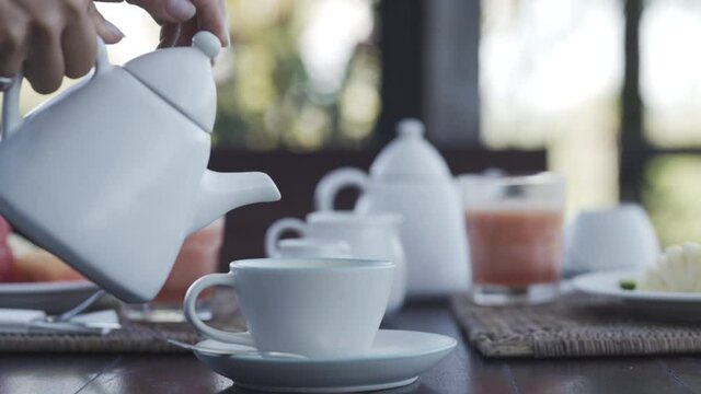 Pouring coffee in a hotel breakfast