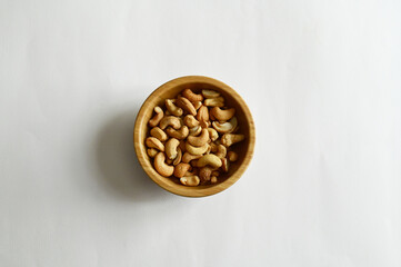 Top Views of Cashew Nuts in a wooden spoon isolated on the white background, Full depth of field.