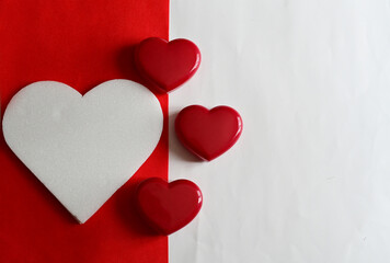 Top Views of Large white heart on red background with red heart shape box on white background for decoration.
