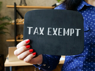  Financial concept meaning TAX EXEMPT with sign on the sheet.