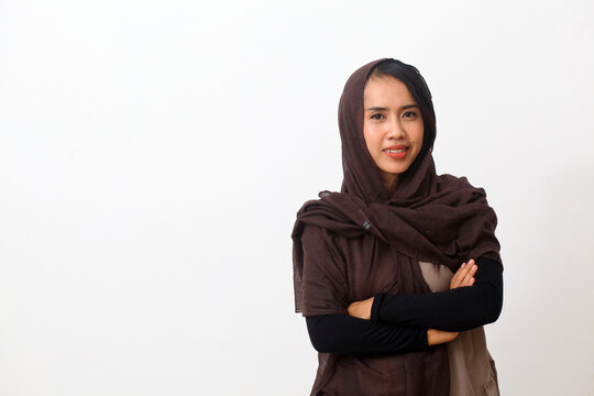 A portrait of happy asian muslim woman wearing a veil or hijab smiling and looking at the camera. Isolated on white background with copy space